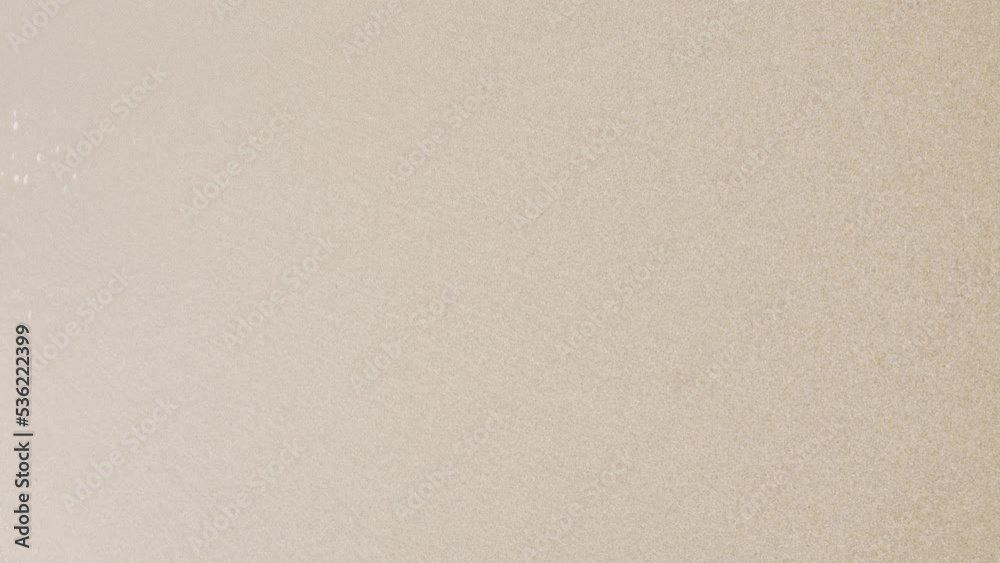 vertical video close up to Sea waves rolling over the fine sand beach, waves break on white sand beach with beautiful foam, tropical summer vacation holiday nature background vertical video close up to Sea waves rolling over the fine sand beach, waves break on white sand beach with beautiful foam, tropical summer vacation holiday nature background