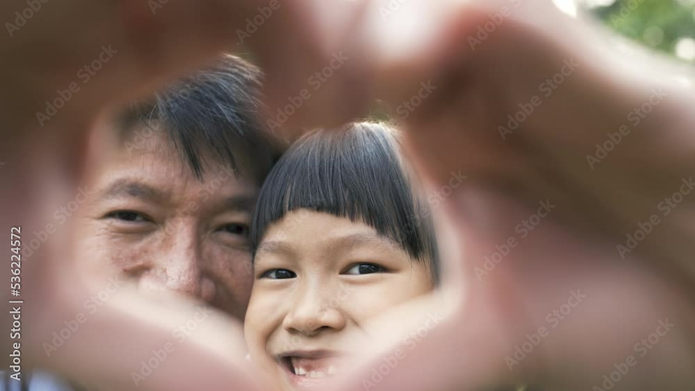 Portrait of fun family daddy and daughter in the park. Beautiful child embraces father. Hands post in heart shape, face to face. Education care, happy Father's Day close up outdoor. Portrait of fun family daddy and daughter in the park. Beautiful child embraces father. Hands post in heart shape, face to face. Education care, happy Father's Day close up outdoor.