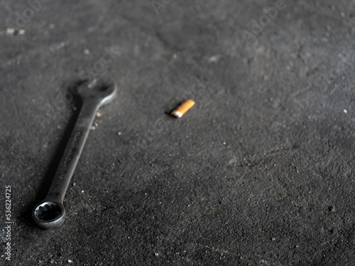 The Combination wrench on the rough concrete flooring