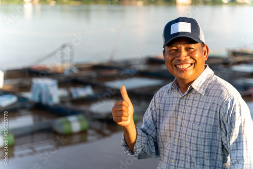 Asian happy aquaculture farmers at ponds and cages. Tilapia Farming. Tilapia fish.