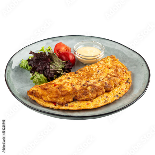 Portion of omelette with salad and sauce