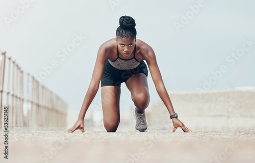 Fototapeta Naklejka Na Ścianę i Meble -  Fitness, runner and woman start running workout along beach, cardio and speed training. Sports, exercise and portrait of black woman prepare for marathon with morning run, serious, focus and intense