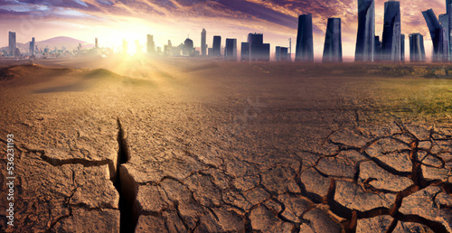 Arid lands in front of the city background. Ecology concept