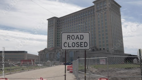 Michigan Central Station in Detroit, Michigan with construction barrels and road closed sign with gimbal video walking forward. photo