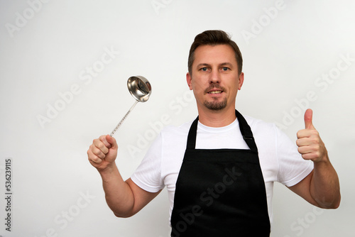 Young chef with ladle isolated on white background