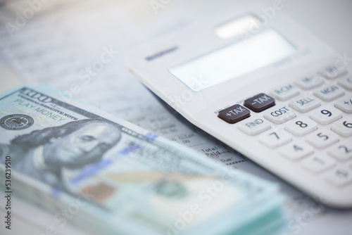 Finance, money and calculator with cash on an accounting desk in an office from above. Wealth, savings and investment with dollar currency on a table for growth, inflation or stock in the economy