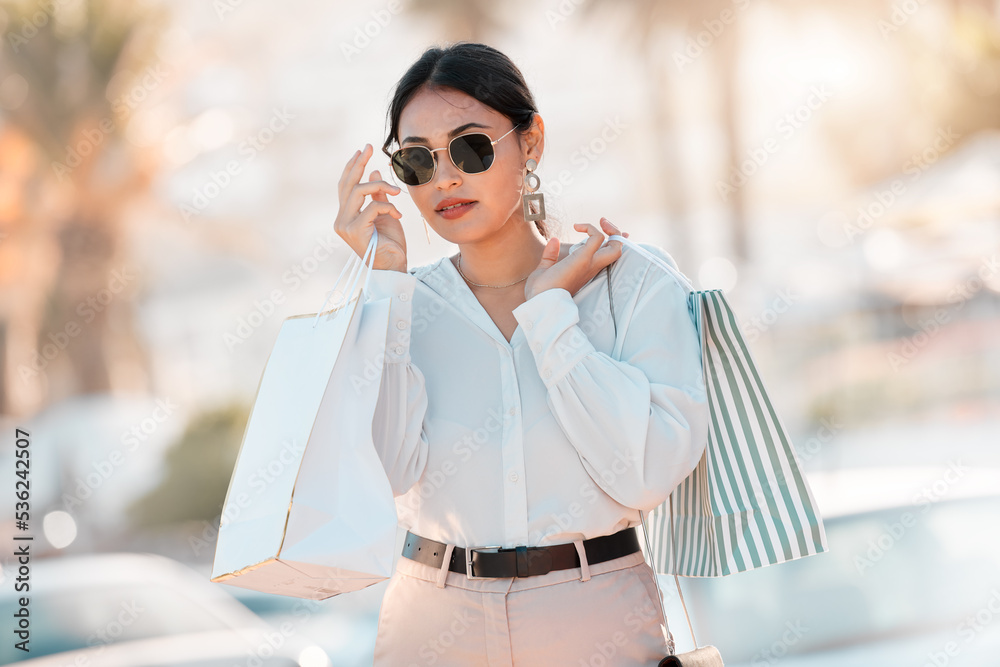 Fototapeta premium Shopping, fashion and city woman with bag walk on street road after buying luxury designer clothes on sales discount. Rich, wealth or chic customer travel in Toronto Canada after retail therapy spree