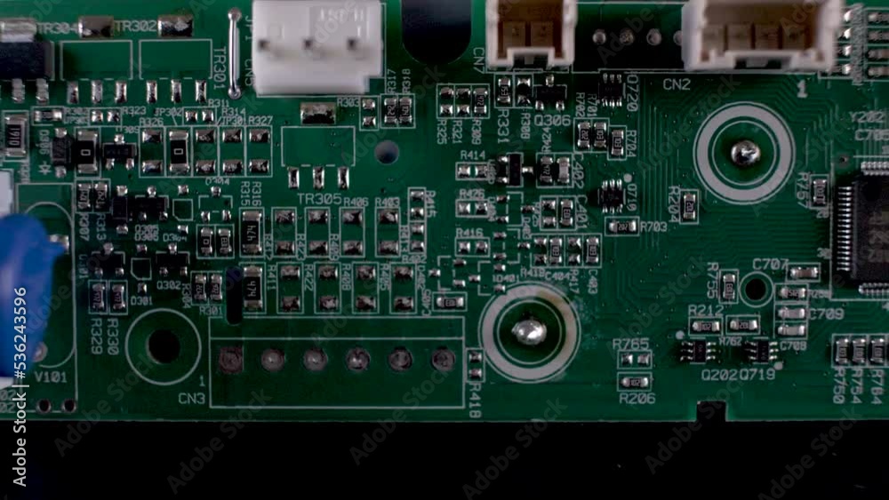 Macro Overhead View Of complex printed Circuit board, an important hardware component for electronics made up of capacitors, resistors and diodes which control the flow of current. dolly right Macro Overhead View Of complex printed Circuit board, an important hardware component for electronics made up of capacitors, resistors and diodes which control the flow of current. dolly right