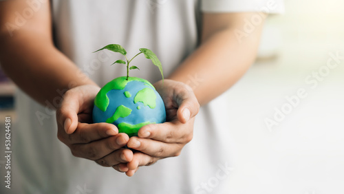 The man holding earth on hand, ecology and environment sustainable concept with sprout on the earth on white background.