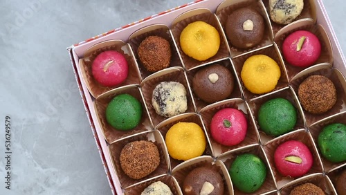 Colourful Diwali sweets pack, Indian sweet festival dish called mithai, Asian sweets, Vegan sweets photo