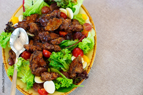 Fototapeta Naklejka Na Ścianę i Meble -  salad with caramelized eggplant, tomatoes, quail eggs and lettuce on a plate.