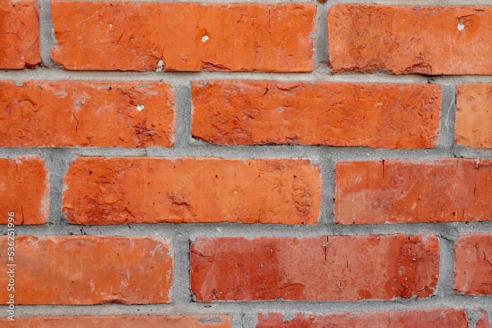 Fragment of old brickwork, closeup. Red brick wall. Potholes and