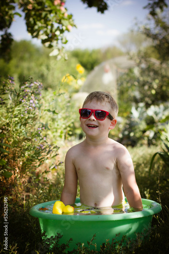 Wallpaper Mural boy playing in a bowl of water in the garden Torontodigital.ca