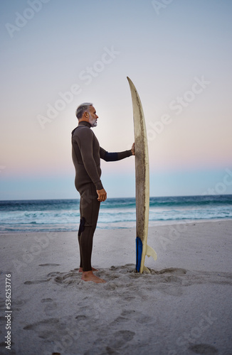 Photography Surfing, surfboard and senior man on beach for water sports adventure trip standing in sand watching sea waves at sunset