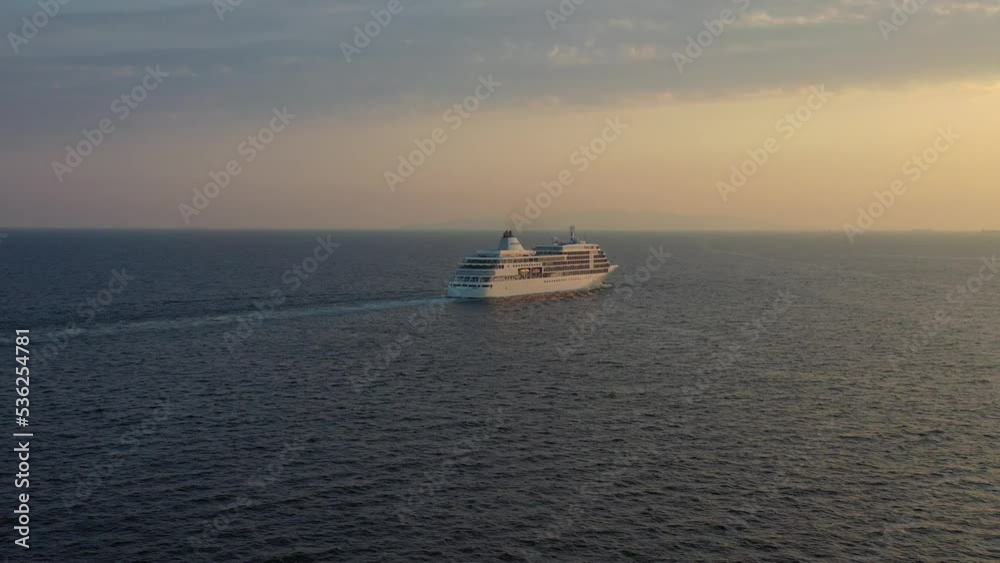 Aerial - Silver Shadow cruise ship departing at sunset from a long distance Aerial - Silver Shadow cruise ship departing at sunset from a long distance