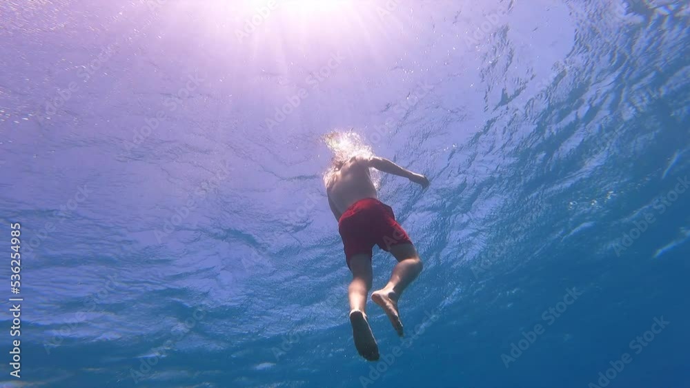 custom made wallpaper toronto digitala young swimmer rises to the surface of the Mediterranean Sea, vacation, warm water and scuba diving