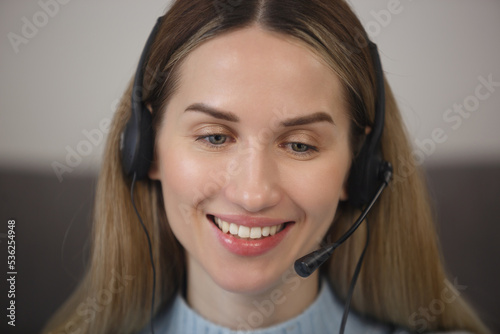 Friendly online support assistant in headset. Portrait of cheerful call center operator