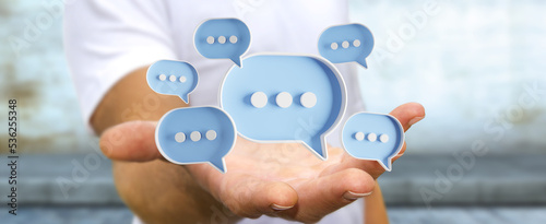 Man touching with his fingers digital speech bubbles talk icons. Minimal conversation or social media messages floating in front of businessman hand. 3D rendering