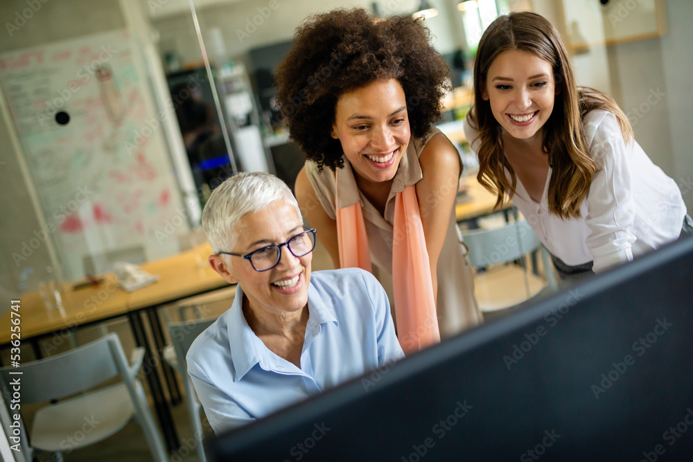 Group of happy multiethnic business people working together, sharing ideas in corporate office. Group of happy multiethnic business people working together, sharing ideas in corporate office.