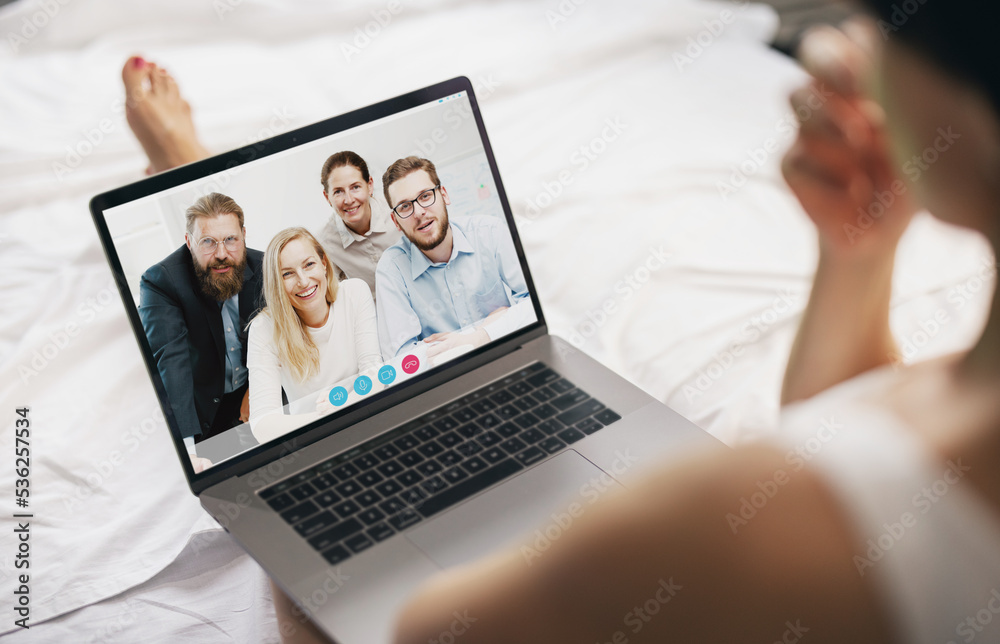 Young woman sitting on bed, having videocall on laptop at home with project team from office. Mature lady chatting using laptop screen, having conversation with friends or parents