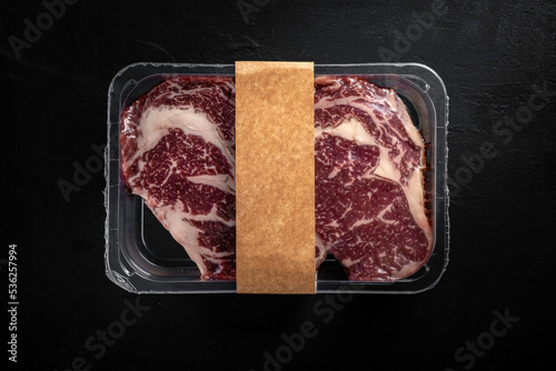 Beef steak in vacuum packaging. Template for meat packaging with an empty space for the logo, top view photo