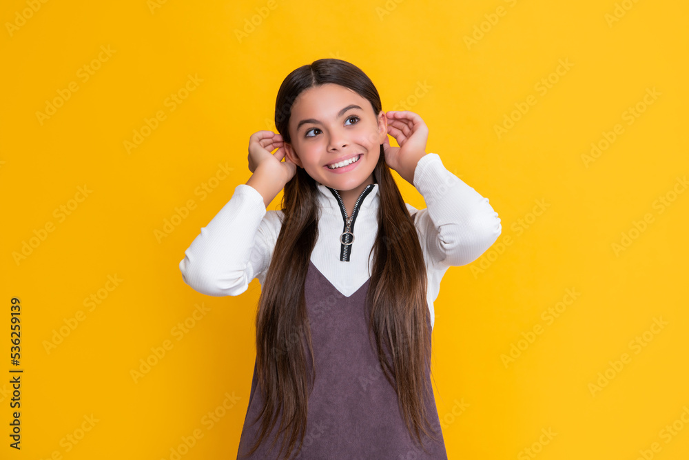 positive child with long hair on yellow background positive child with long hair on yellow background