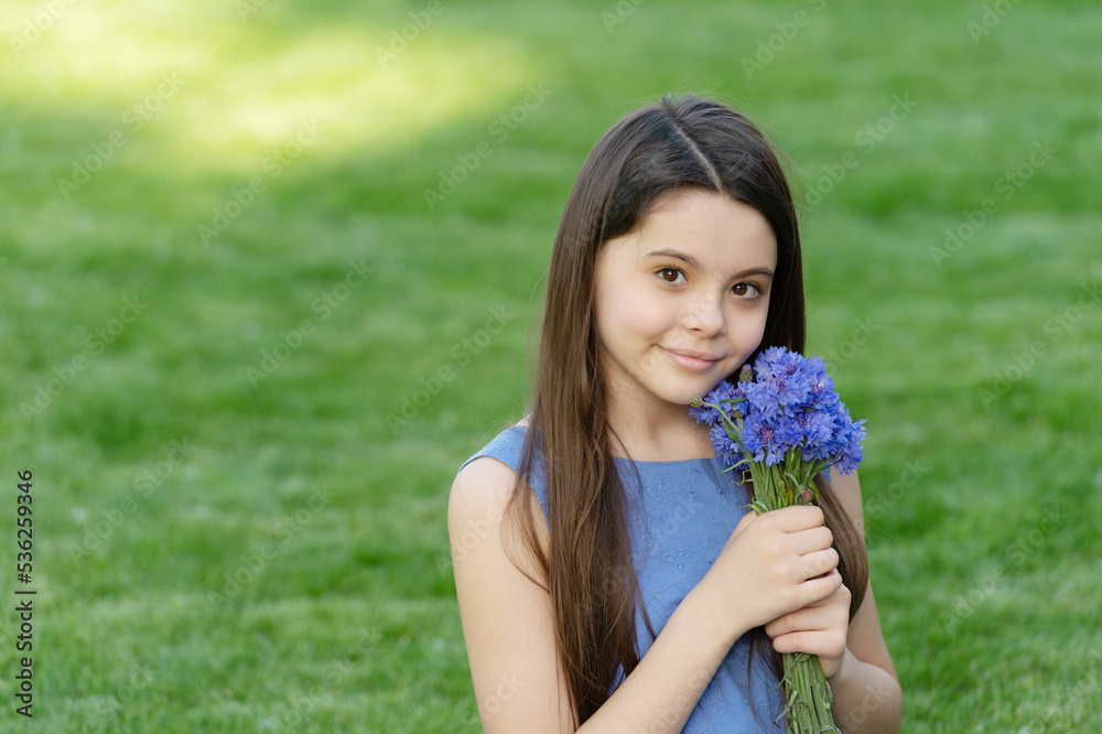 teen girl with flowers. pretty girl on grass. cute girl portrait. copy space teen girl with flowers. pretty girl on grass. cute girl portrait. copy space