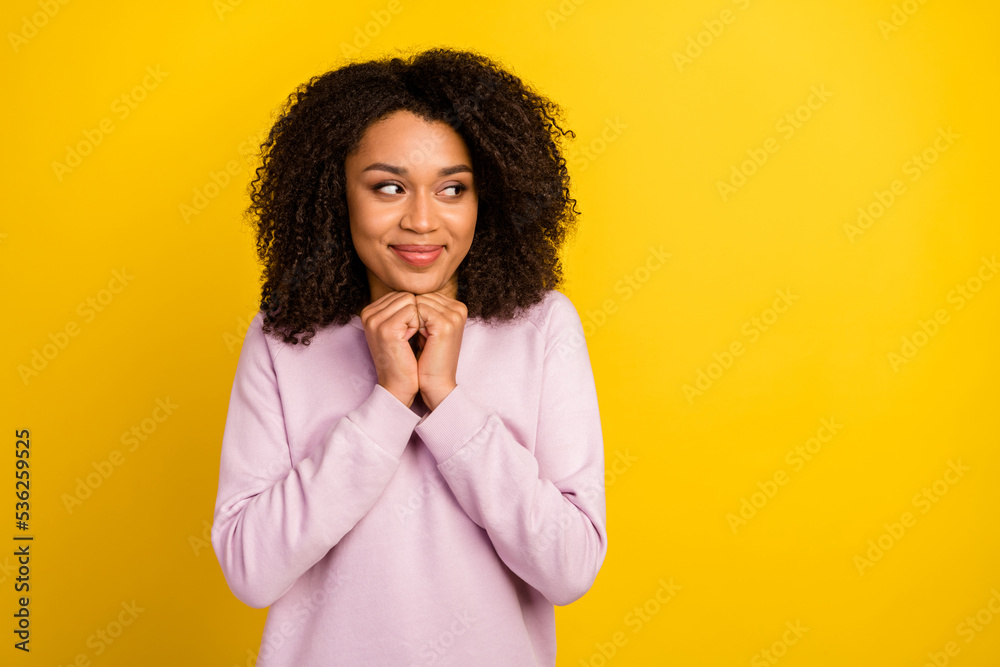 Photo of young lovely lady arms touch chin guess dream look empty space plan isolated over yellow color background Photo of young lovely lady arms touch chin guess dream look empty space plan isolated over yellow color background