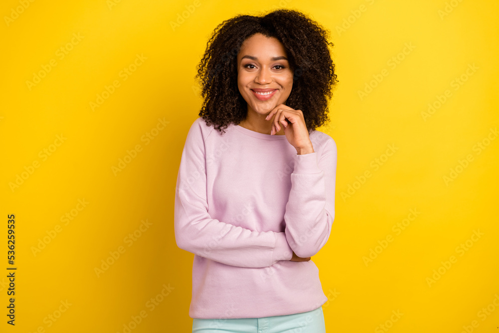 Photo of young cheerful woman wear casual clothes hand touch chin dream think isolated over yellow color background Photo of young cheerful woman wear casual clothes hand touch chin dream think isolated over yellow color background