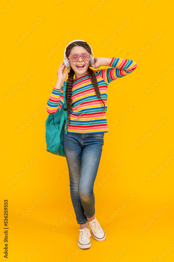 Teenage girl singing song after music school yellow background, music. Education in music Teenage girl singing song after music school yellow background, music. Education in music
