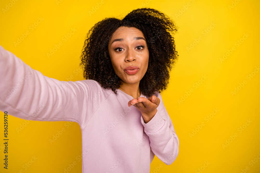 Photo of young woman make selfie pouted lips send air kiss flirty romance isolated over yellow color background Photo of young woman make selfie pouted lips send air kiss flirty romance isolated over yellow color background