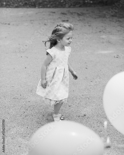 little girl playing with ball in a park photo