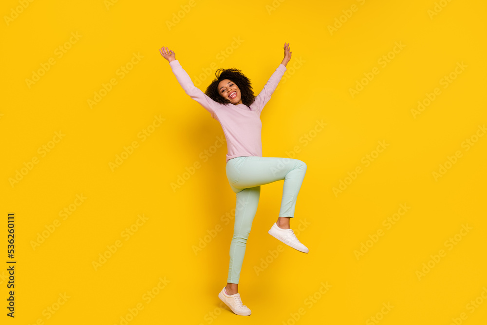 Full length profile side photo of young pretty woman good mood playful isolated over yellow color background