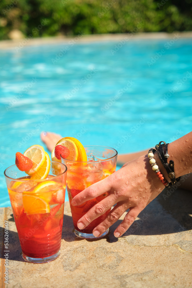 women's hands with a glass of cocktail women's hands with a glass of cocktail