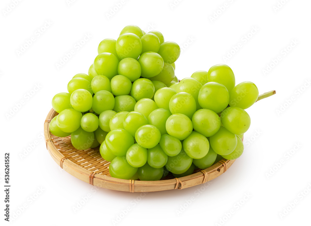 Shine Muscat in a bamboo colander on a white background. Shine Muscat in a bamboo colander on a white background.