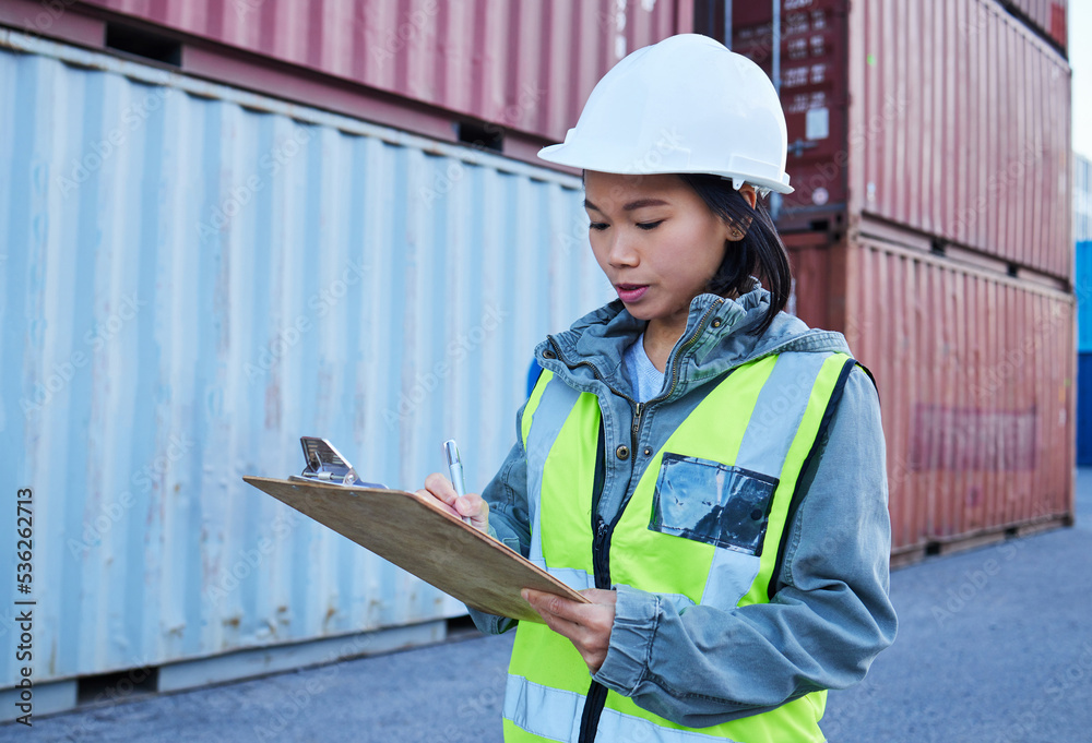 Logistics, shipping and asian woman engineer writing checklist report for inspection or delivery control of cargo containers at shipyard. Supply chain worker in safety helmet at a warehouse in Korea Logistics, shipping and asian woman engineer writing checklist report for inspection or delivery control of cargo containers at shipyard. Supply chain worker in safety helmet at a warehouse in Korea
