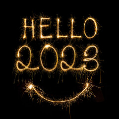 Happy New Year 2023. Sparkling burning text Happy New Year 2023 isolated on black background. Beautiful Glowing golden overlay object for design holiday greeting card