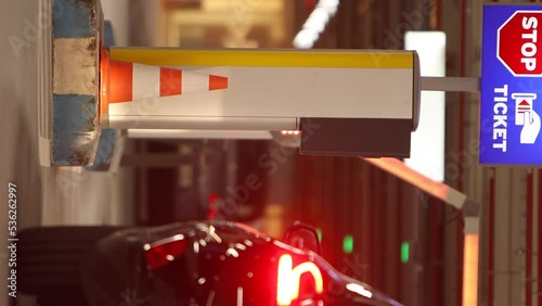 vertical video, smart phone screen,  barrier for the passage of vehicles in a subway parking lot.