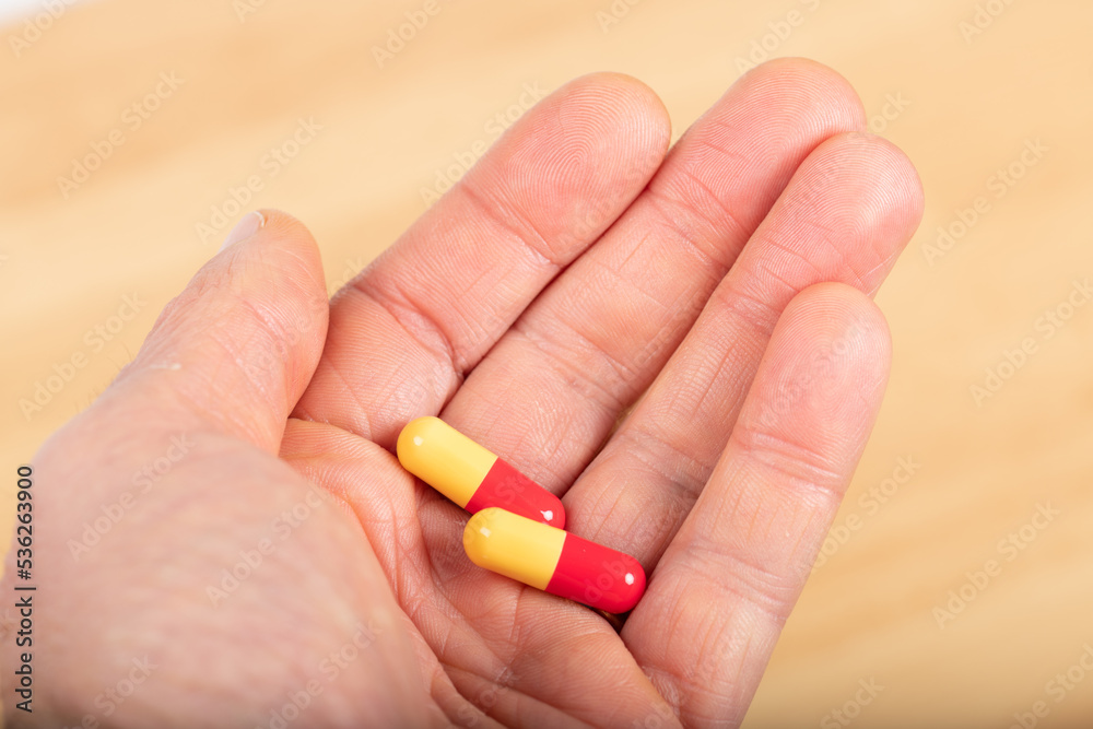 Medicine : capsules in the hand of a man Medicine : capsules in the hand of a man