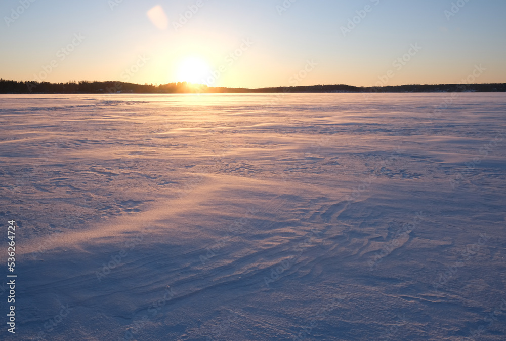 Beautiful sunset over a snowy field.