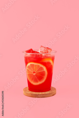 Watermelon agua fresca in disposable take away plastic cup. Watermelon Melon mojito fresh red drink. Refreshing summer cocktail on pink background photo