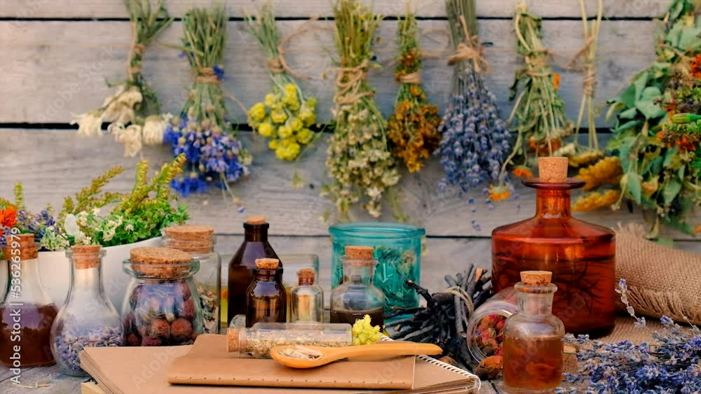 Tinctures and extracts of herbs in a jar. Selective focus.