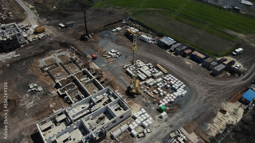 crane moves building materials for house construction. 4k drone footage crane moves building materials for house construction. 4k drone footage