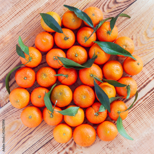 Mandarines in the middle of wooden background