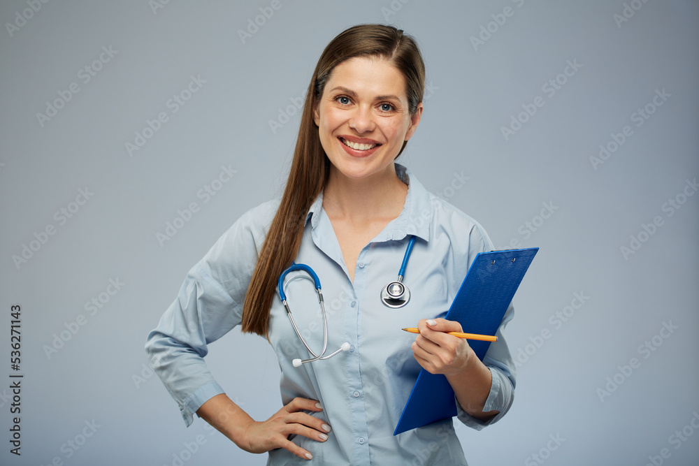 Doctor woman in medical uniform holding clipboard with health insurance. Isolated portrait of female medical worker