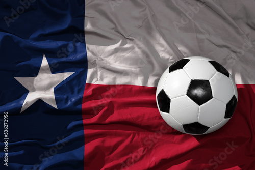 vintage football ball on the waveing texas state flag background. 3D illustration
