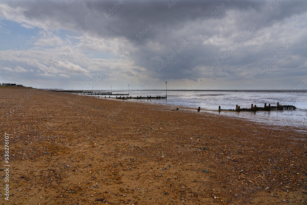 Fototapeta premium Summer rain clouds gather ominously over Hunstanton beach.
