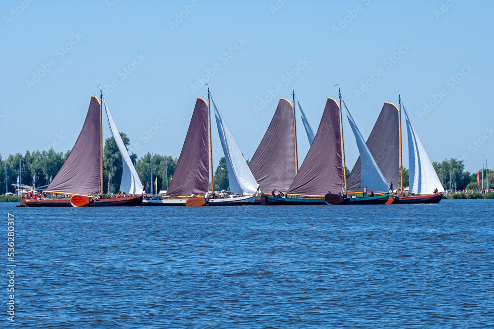 Naklejka premium Traditional Frisian wooden sailing ships in a yearly competition in the Netherlands