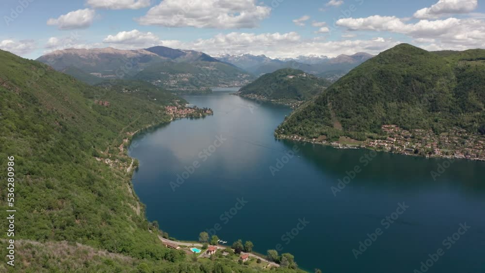 Aerial View of Lake Lugano from Porto Ceresio in Italy and surrounding mountains in a beautiful cloudy day Aerial View of Lake Lugano from Porto Ceresio in Italy and surrounding mountains in a beautiful cloudy day