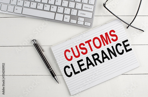 text CUSTOMS CLEARANCE on keyboard on white background photo
